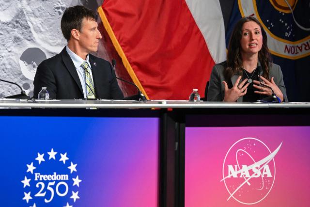 NASA flight director Rick Henfling (L) listens to Kelsey Young (R) Artemis II lunar science lead speak during a status briefing of the Artemis II crewed lunar mission at Johnson Space Center in Houston, Texas, on April 5, 2026. The four astronauts on NASA's Artemis 2 mission prepared April 5 to enter the Moon's "sphere of influence," having already taking in sights of the lunar surface never before seen by human eyes. As they awoke for day five of the 10-day mission, their Orion spaceship was nearly 215,000 miles (346,000 kilometers) from Earth and 65,000 miles from the Moon, according to NASA's online dashboard. (Photo by RONALDO SCHEMIDT / AFP)