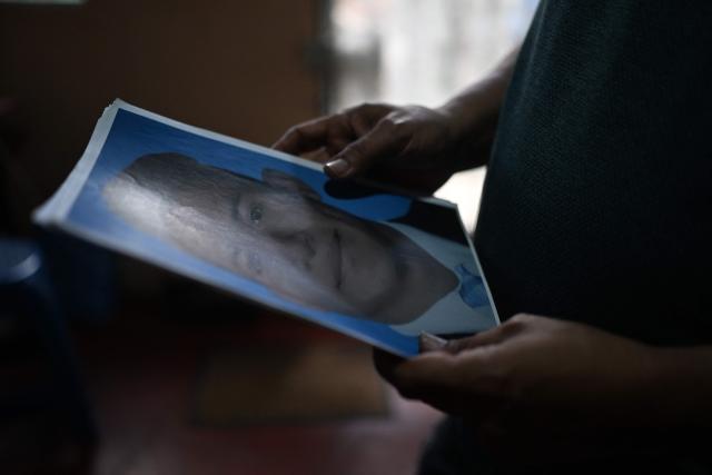Reynaldo Santos, 58, father of Jonathan Santos, who was previously detained and is now being processed under the state of exception, shows a photograph of his son during an interview with AFP at his home in Soyapango, El Salvador, on March 9, 2026. Mass trials in El Salvador are moving forward against some 91,000 people detained under the state of exception imposed by President Nayib Bukele four years ago, in his anti-gang "war." (Photo by AFP)