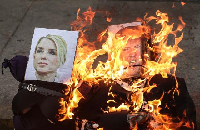 An effigy depicting US President Donald Trump burns during the Burning of Judas ritual as part of Easter celebrations on a street in the 23 de Enero neighborhood in Caracas on April 5, 2026. (Photo by Jesus VARGAS / AFP)