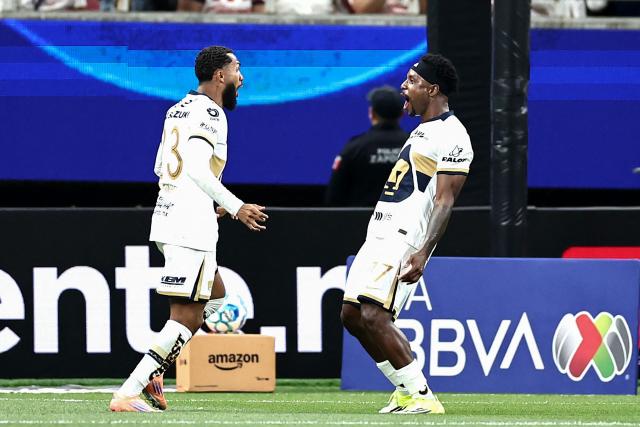 Pumas' Colombian defender #77 Alvaro Angulo (R) celebrates scoring his team's second goal with teammate Brazilian forward #23 Juninho Vieira (L) during the Liga MX Clausura football match between Guadalajara and Pumas at Akron stadium in Zapopan, Jalisco state, Mexico, on April 5, 2026. (Photo by Ulises Ruiz / AFP)