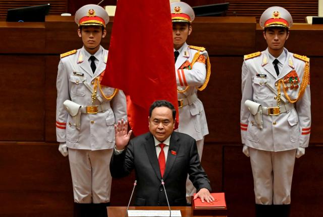 Vietnam's newly elected National Assembly Chairman Tran Thanh Man (C) takes his oath during the opening session of the National Assembly in Hanoi on April 6, 2026. (Photo by Dang ANH / AFP)