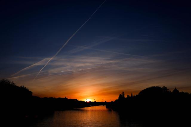 The sun rises over the Seine river in Paris on April 6, 2026. (Photo by Kenzo TRIBOUILLARD / AFP)