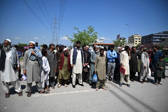 Commuters wait to travel on a free state-run public bus in Islamabad on April 6, 2026. State-run public transport in Pakistan's capital and most populous province will be free for the coming month, officials said on April 3, after the government drastically raised fuel prices due to the Iran war. (Photo by Aamir QURESHI / AFP)