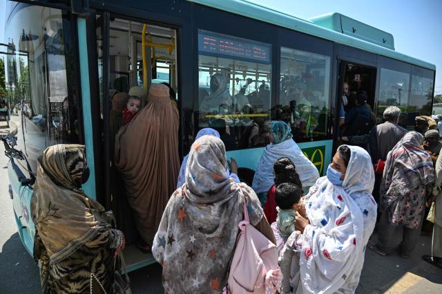 Commuters board a free state-run public bus in Islamabad on April 6, 2026. State-run public transport in Pakistan's capital and most populous province will be free for the coming month, officials said on April 3, after the government drastically raised fuel prices due to the Iran war. (Photo by Aamir QURESHI / AFP)