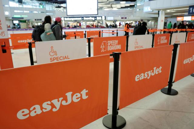 People walk at the EasyJet check-in counter while some of the airline's staff are on strike at Orly Airport, in the Paris suburbs, on April 6, 2026. (Photo by Thomas SAMSON / AFP)