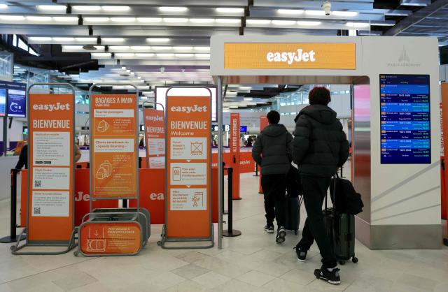 Passengers arrive at the EasyJet check-in counter while some of the airline's staff are on strike at Orly Airport, in the Paris suburbs, on April 6, 2026. (Photo by Thomas SAMSON / AFP)