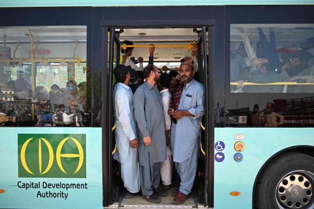 Commuters travel on an overcrowded free state-run public bus in Islamabad on April 6, 2026. State-run public transport in Pakistan's capital and most populous province will be free for the coming month, officials said on April 3, after the government drastically raised fuel prices due to the Iran war. (Photo by Aamir QURESHI / AFP)