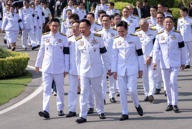 Thailand's Prime Minister Anutin Charnvirakul (C) and members of the new cabinet arrive for a group photo session before being sworn in to office at Government House in Bangkok on April 6, 2026. (Photo by Chanakarn LAOSARAKHAM / AFP)
