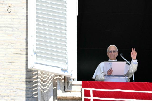 Pope Leo XIV waves to the crowd from the window of the apostolic palace overlooking St. Peter's square during the Regina Coeli prayer in The Vatican on April 6, 2026. (Photo by Alberto PIZZOLI / AFP)