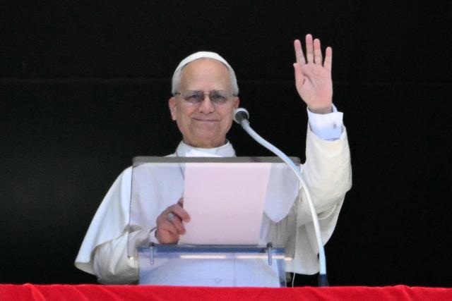 Pope Leo XIV addresses the crowd from the window of the apostolic palace overlooking St. Peter's square during the Regina Coeli prayer in The Vatican on April 6, 2026. (Photo by Alberto PIZZOLI / AFP)
