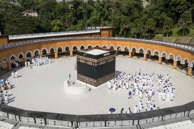 An aerial image shows prospective Indonesian pilgrims practicing circumambulation rituals around a replica of the Kaaba, Islam’s holiest shrine, during a training session at the Al Mahmudah Manasik Training Center (AMTC) in South Tangerang on April 5, 2026. The centre provides a simulated experience of Mecca’s pilgrimage sites ahead of the Hajj season in late May. Indonesia, home to the world’s largest Muslim population, has been allocated a Hajj quota of 221,000 pilgrims for 2026, but faces long waiting lists that can stretch for decades in some regions. (Photo by AFP)