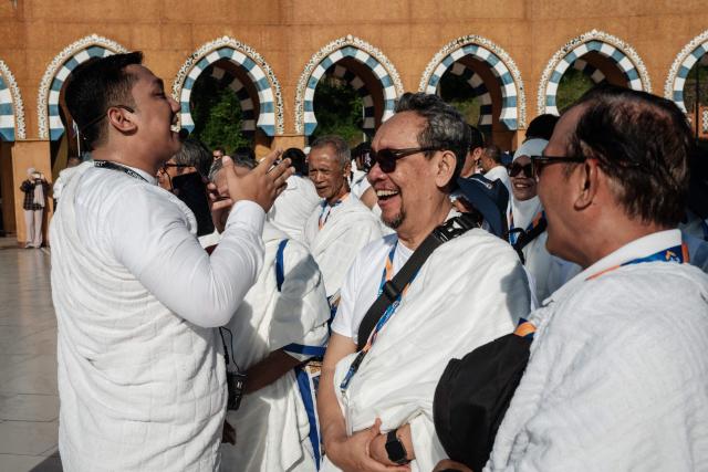 Prospective Indonesian pilgrims react as they practice circumambulation rituals around a replica of the Kaaba, Islam’s holiest shrine, during a training session at the Al Mahmudah Manasik Training Center (AMTC) in South Tangerang on April 5, 2026. The centre provides a simulated experience of Mecca’s pilgrimage sites ahead of the Hajj season in late May. Indonesia, home to the world’s largest Muslim population, has been allocated a Hajj quota of 221,000 pilgrims for 2026, but faces long waiting lists that can stretch for decades in some regions. (Photo by YASUYOSHI CHIBA / AFP)