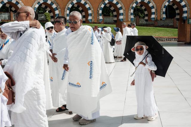 A six-year-old girl walks with her family members as prospective Indonesian pilgrims practice a ritual around a replica of the Kaaba, Islam’s holiest shrine, at the Al Mahmudah Manasik Training Center (AMTC), a Hajj training facility featuring replicas of key pilgrimage sites, in South Tangerang on April 5, 2026. The centre provides a simulated experience of Mecca’s pilgrimage sites ahead of the Hajj season in late May. Indonesia, home to the world’s largest Muslim population, has been allocated a Hajj quota of 221,000 pilgrims for 2026, but faces long waiting lists that can stretch for decades in some regions. (Photo by YASUYOSHI CHIBA / AFP)