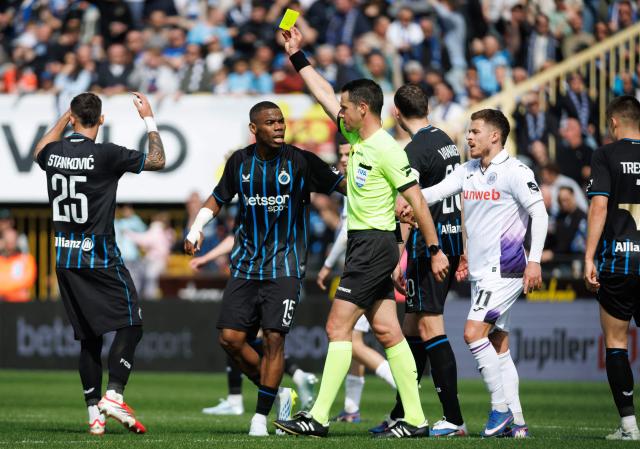 Club Brugge's Serbian midfielder #25 Aleksandar Stankovic (L) receives a yellow card during the Belgian "Pro League" champions' play-off (day 1 out of 10) football match between Club Brugge KV and RSC Anderlecht at the Jan Breydel Stadium in Bruges on April 6, 2026. (Photo by KURT DESPLENTER / Belga / AFP) / Belgium OUT