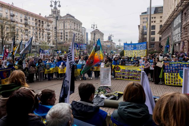 Relatives of missing Ukrainian soldiers hold flags, banners and photographs bearing the portraits of missing soldiers during a rally near Kyiv city council building, in Kyiv, on April 6, 2026, amid the Russian invasion of Ukraine. (Photo by Tetiana DZHAFAROVA / AFP)