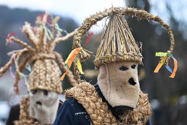 Polish bachelors wearing traditional straw costumes parade through the streets and splash water on the villagers in a ritual for fertility and a bountiful harvest as they celebrate Easter Monday in Dobra, Lesser Poland Voivodeship on April 6, 2026. (Photo by Sergei GAPON / AFP)