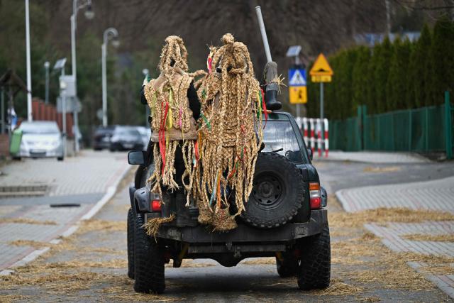 Polish bachelors wearing traditional straw costumes parade through the streets and splash water on the villagers in a ritual for fertility and a bountiful harvest as they celebrate Easter Monday in Dobra, Lesser Poland Voivodeship on April 6, 2026. (Photo by Sergei GAPON / AFP)