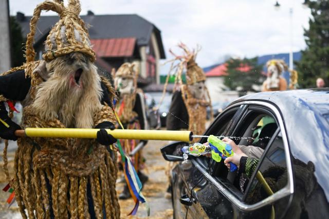 Polish bachelors wearing traditional straw costumes parade through the streets and splash water on the villagers in a ritual for fertility and a bountiful harvest as they celebrate Easter Monday in Dobra, Lesser Poland Voivodeship on April 6, 2026. (Photo by Sergei GAPON / AFP)