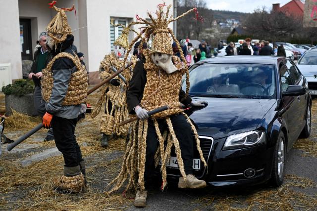 Polish bachelors wearing traditional straw costumes parade through the streets and splash water on the villagers in a ritual for fertility and a bountiful harvest as they celebrate Easter Monday in Dobra, Lesser Poland Voivodeship on April 6, 2026. (Photo by Sergei GAPON / AFP)