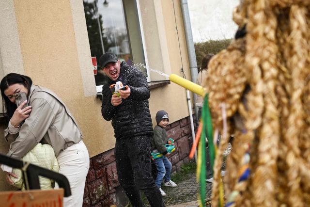 Polish bachelors wearing traditional straw costumes parade through the streets and splash water on the villagers in a ritual for fertility and a bountiful harvest as they celebrate Easter Monday in Dobra, Lesser Poland Voivodeship on April 6, 2026. (Photo by Sergei GAPON / AFP)