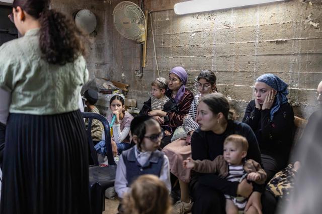 TOPSHOT - Ultra-Orthodox Jews take cover inside a bomb shelter in Bnei Brak in central Israel on April 6, 2026. Israeli strikes killed the intelligence chief of Iran's Revolutionary Guards, as the Islamic republic on April 6 defied threats from the US President to devastate civilian infrastructure if it does not reopen the Strait of Hormuz. (Photo by Ilia YEFIMOVICH / AFP) / 