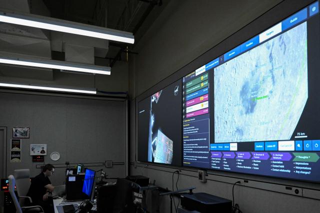 A worker is seen inside the Science Mission Operations Room (SMOR) at Johnson Space Center in Houston, Texas, on April 6, 2026. The Artemis astronauts entered the final phase of their run-up to a lunar loop on Monday, a tipping point of sorts that means the Moon's gravity is now having a stronger pull on the spacecraft than Earth's. The Orion capsule will now whip around the Moon, setting the crew up to travel farther from our home planet than any human before. (Photo by RONALDO SCHEMIDT / AFP)