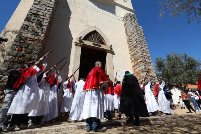 Brotherhood members shoot rifles outside the Saint Spyridon "Greek" church during a procession on Easter Monday in Cargese, the French Mediterranean island of Corsica, on April 6, 2026. (Photo by Pascal POCHARD-CASABIANCA / AFP)