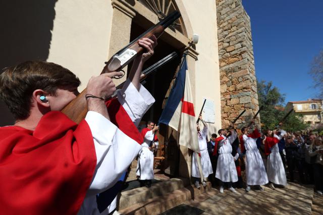 Brotherhood members shoot rifles outside the Saint Spyridon "Greek" church during a procession on Easter Monday in Cargese, the French Mediterranean island of Corsica, on April 6, 2026. (Photo by Pascal POCHARD-CASABIANCA / AFP)