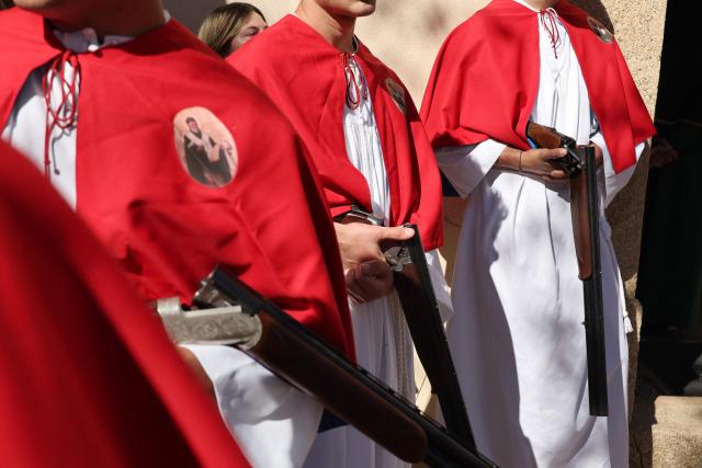Brotherhood members hold rifles prior to shooting them outside the Saint Spyridon "Greek" church as part of a procession on Easter Monday in Cargese, the French Mediterranean island of Corsica, on April 6, 2026. (Photo by Pascal POCHARD-CASABIANCA / AFP)
