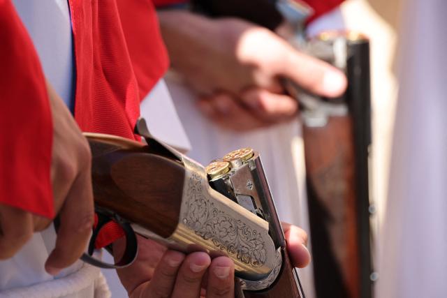 Brotherhood members hold rifles prior to shooting them outside the Saint Spyridon "Greek" church as part of a procession on Easter Monday in Cargese, the French Mediterranean island of Corsica, on April 6, 2026. (Photo by Pascal POCHARD-CASABIANCA / AFP)