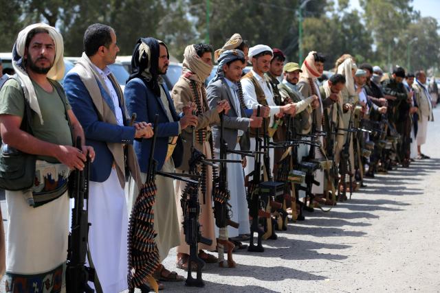 Supporters of the Iran-backed Houthi movement brandish their weapons as they rally in solidarity with Iran and Lebanon amid the US-Israeli war with Iran, in the capital Sanaa on April 6, 2026. The Israeli military said on April 5, 2026, it had detected a missile launched from Yemen towards Israeli territory, the fifth such attack since the start of the Middle East war. (Photo by Mohammed HUWAIS / AFP)