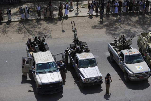 Members of the Iran-backed Houthi movement brandish their weapons as they rally in solidarity with Iran and Lebanon amid the US-Israeli war with Iran, in the capital Sanaa on April 6, 2026. The Israeli military said on April 5, 2026, it had detected a missile launched from Yemen towards Israeli territory, the fifth such attack since the start of the Middle East war. (Photo by Mohammed HUWAIS / AFP)