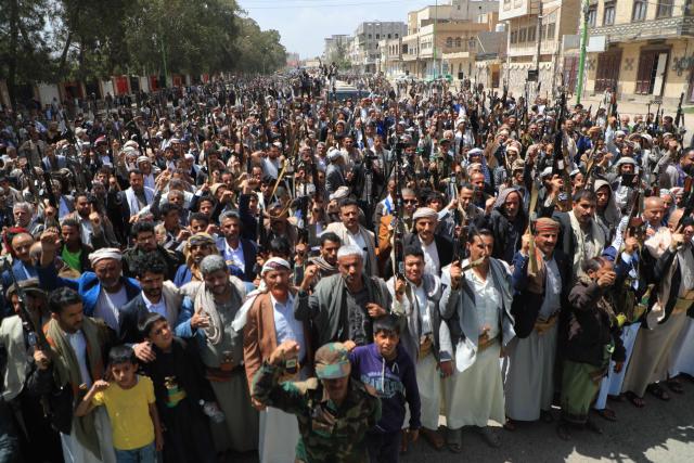 Supporters of the Iran-backed Houthi movement brandish their weapons as they rally in solidarity with Iran and Lebanon amid the US-Israeli war with Iran, in the capital Sanaa on April 6, 2026. The Israeli military said on April 5, 2026, it had detected a missile launched from Yemen towards Israeli territory, the fifth such attack since the start of the Middle East war. (Photo by Mohammed HUWAIS / AFP)