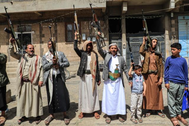 Supporters of the Iran-backed Houthi movement brandish their weapons as they rally in solidarity with Iran and Lebanon amid the US-Israeli war with Iran, in the capital Sanaa on April 6, 2026. The Israeli military said on April 5, 2026, it had detected a missile launched from Yemen towards Israeli territory, the fifth such attack since the start of the Middle East war. (Photo by Mohammed HUWAIS / AFP)