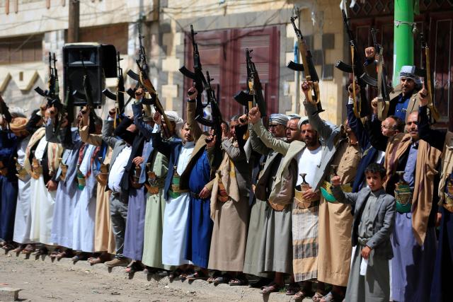 Supporters of the Iran-backed Houthi movement brandish their weapons as they rally in solidarity with Iran and Lebanon amid the US-Israeli war with Iran, in the capital Sanaa on April 6, 2026. The Israeli military said on April 5, 2026, it had detected a missile launched from Yemen towards Israeli territory, the fifth such attack since the start of the Middle East war. (Photo by Mohammed HUWAIS / AFP)