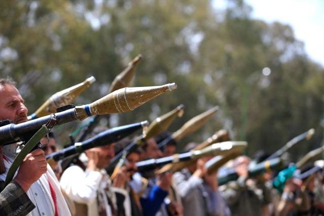 Supporters of the Iran-backed Houthi movement brandish their weapons as they rally in solidarity with Iran and Lebanon amid the US-Israeli war with Iran, in the capital Sanaa on April 6, 2026. The Israeli military said on April 5, 2026, it had detected a missile launched from Yemen towards Israeli territory, the fifth such attack since the start of the Middle East war. (Photo by Mohammed HUWAIS / AFP)