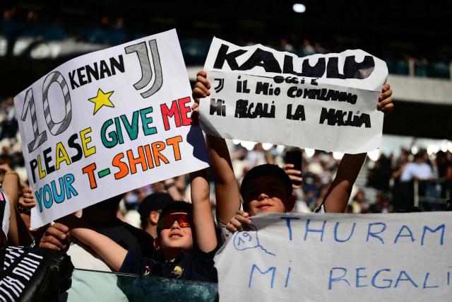Young supporters hold posters asking for players jerseys during the Italian Serie A football match between Juventus and Genoa at the Allianz stadium in Turin, on April 6, 2026. (Photo by Marco BERTORELLO / AFP)