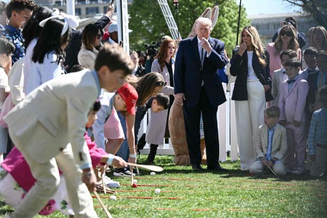 US President Donald Trump and First Lady Melania Trump blow whistles as children participate in the annual Easter Egg Roll on the South Lawn of the White House on April 6, 2026, in Washington, DC. (Photo by Brendan SMIALOWSKI / AFP)