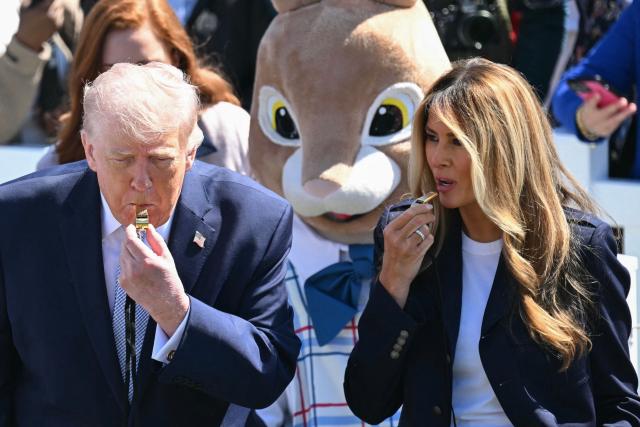 US President Donald Trump and First Lady Melania Trump blow whistles as children participate in the annual Easter Egg Roll on the South Lawn of the White House on April 6, 2026, in Washington, DC. (Photo by SAUL LOEB / AFP)
