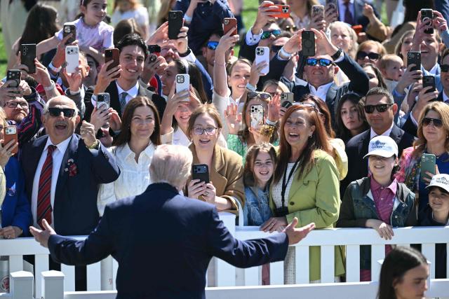 US President Donald Trump greets the crowd during the annual Easter Egg Roll on the South Lawn of the White House on April 6, 2026, in Washington, DC. (Photo by SAUL LOEB / AFP)