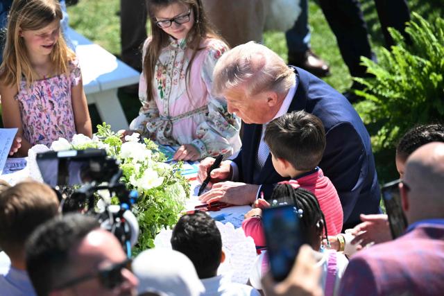 US President Donald Trump participates in a coloring activity with children as he hosts the annual Easter Egg Roll on the South Lawn of the White House on April 6, 2026, in Washington, DC. (Photo by SAUL LOEB / AFP)