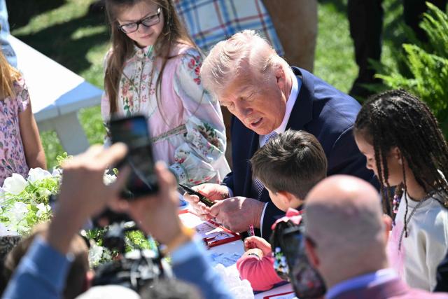 US President Donald Trump participates in a coloring activity with children as he hosts the annual Easter Egg Roll on the South Lawn of the White House on April 6, 2026, in Washington, DC. (Photo by SAUL LOEB / AFP)