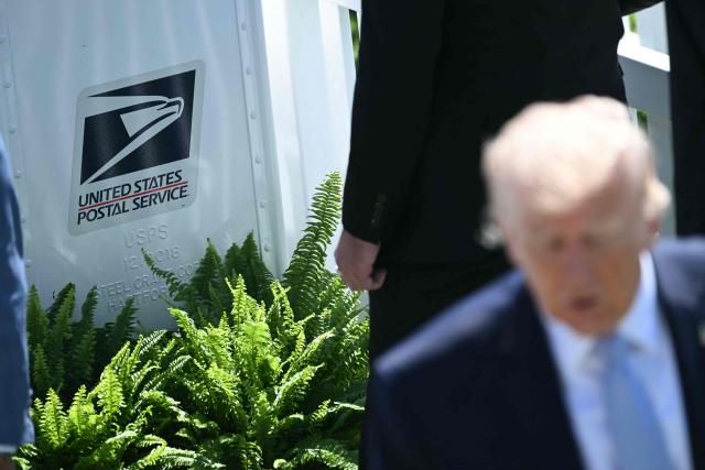 A Postal Service mail box is seen as US President Donald Trump speaks to members of the media during the annual Easter Egg Roll on the South Lawn of the White House on April 6, 2026, in Washington, DC. (Photo by SAUL LOEB / AFP)