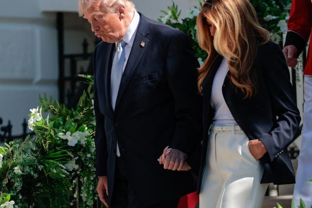 US President Donald Trump and First Lady Melania Trump walk from the balcony to the lawn as they host the annual Easter Egg Roll on the South Lawn of the White House on April 6, 2026, in Washington, DC. (Photo by Kent Nishimura / AFP)