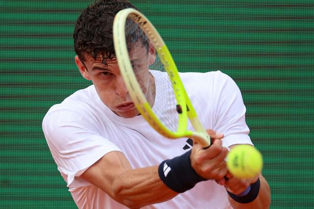 Argentinia's Juan Manuel Cerundolo plays a backhand return to Monaco's Valentin Vacherot during the Monte Carlo ATP Masters Series Tournament round of 64 tennis match on Court Rainier III at the Monte-Carlo Country Club in Roquebrune-Cap-Martin, south-eastern France on April 6, 2026. (Photo by Valery HACHE / AFP)