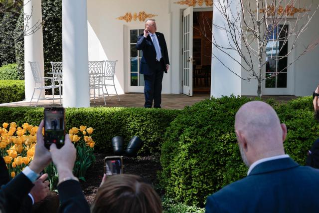 US President Donald Trump listens to questions from reporters outside the Oval Office after hosting the annual Easter Egg Roll on the South Lawn of the White House on April 6, 2026, in Washington, DC. (Photo by Kent Nishimura / AFP)
