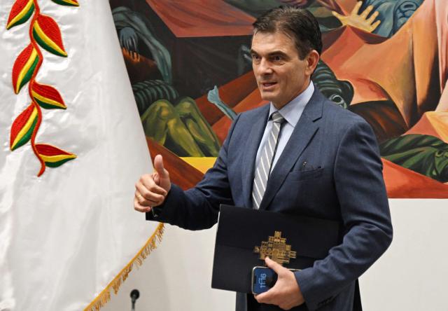 Bolivia's President Rodrigo Paz gestures on arrival for a press conference after the government revoked decrees on direct contracting and the awarding of public works contracts, at the Casa Grande del Pueblo, the seat of the Government Palace, in La Paz, on April 6, 2026. (Photo by Aizar RALDES / AFP)