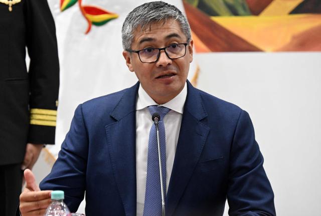 Bolivia's Economy Minister Jose Gabriel Espinoza speaks during a press conference after the government revoked decrees on direct contracting and the awarding of public works contracts, at the Casa Grande del Pueblo, the seat of the Government Palace, in La Paz, on April 6, 2026. (Photo by Aizar RALDES / AFP)