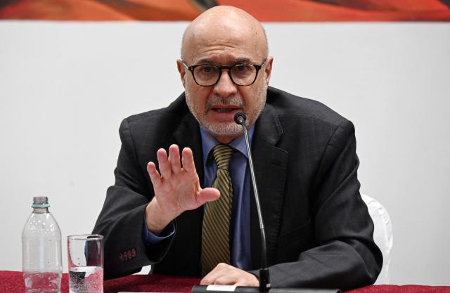 Bolivia's Presidency Minister Jose Luis Lupo (L) speaks during a press conference after the government revoked decrees on direct contracting and the awarding of public works contracts, at the Casa Grande del Pueblo, the seat of the Government Palace, in La Paz, on April 6, 2026. (Photo by Aizar RALDES / AFP)