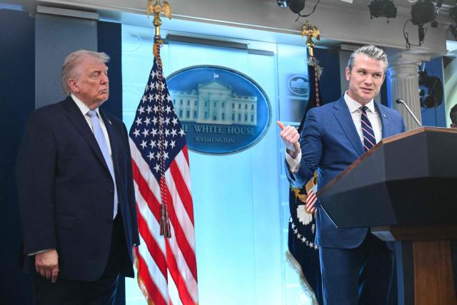 US President Donald Trump looks on as US Secretary of Defense Pete Hegseth speaks about the conflict in Iran in the James S. Brady Press Briefing Room of the White House on April 6, 2026, in Washington, DC. (Photo by SAUL LOEB / AFP)